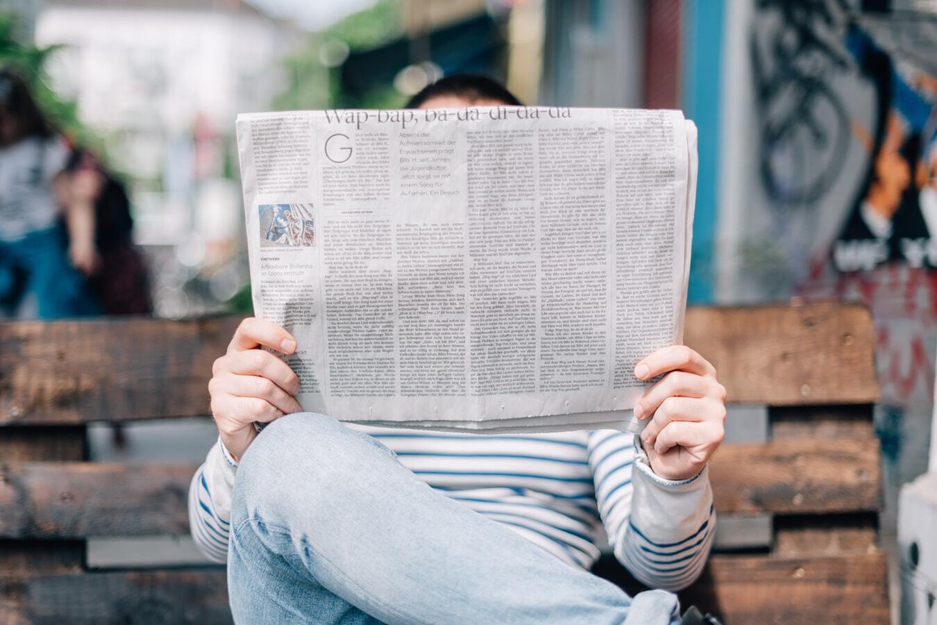 Person reading a newspaper